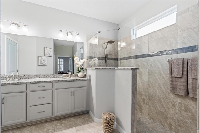 bathroom featuring vanity and tiled shower