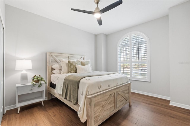 bedroom featuring ceiling fan and dark hardwood / wood-style floors