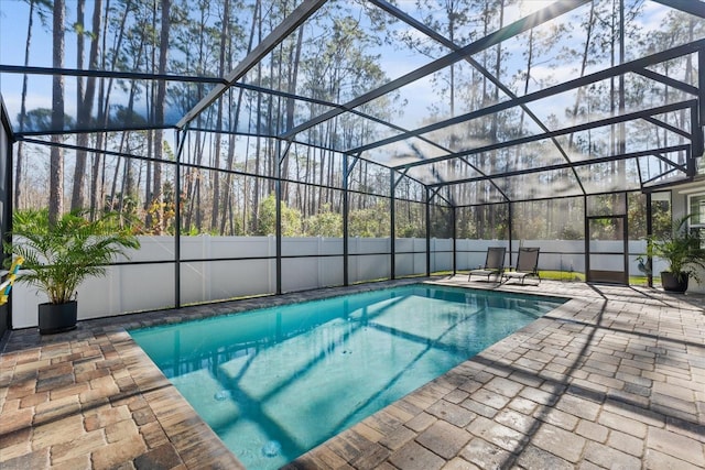 view of pool with a patio and glass enclosure