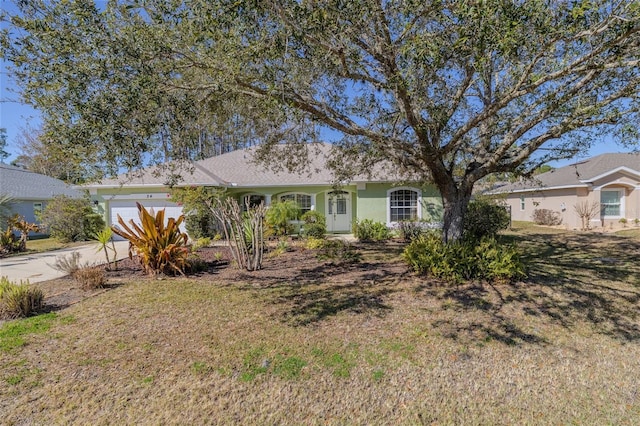 ranch-style home with a garage and a front yard