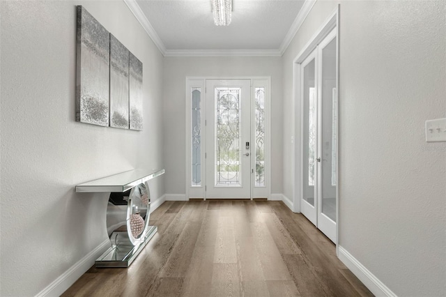 entryway with crown molding and hardwood / wood-style floors