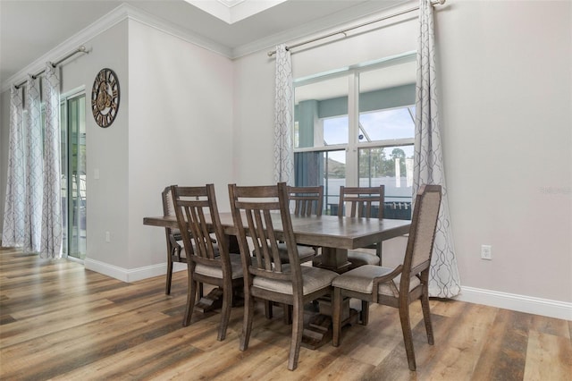 dining area featuring crown molding and hardwood / wood-style floors