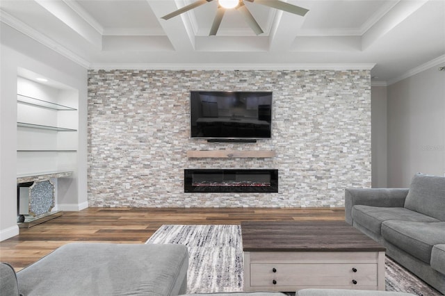 living room with built in features, wood-type flooring, coffered ceiling, ceiling fan, and crown molding