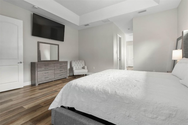 bedroom with dark hardwood / wood-style floors