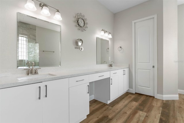 bathroom featuring vanity, hardwood / wood-style flooring, and a shower with shower door