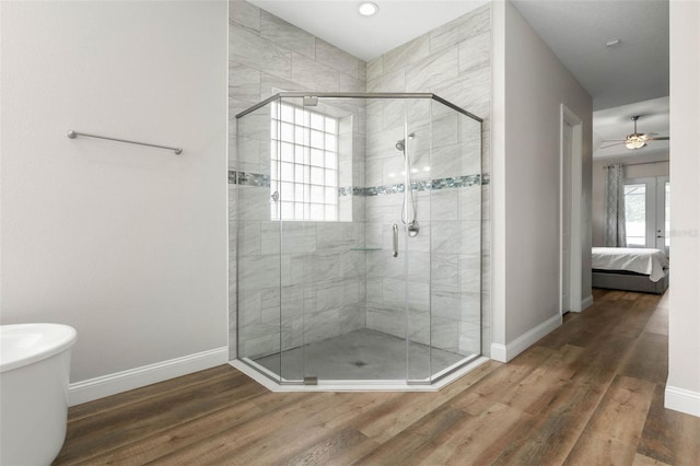 bathroom with hardwood / wood-style floors, french doors, and walk in shower