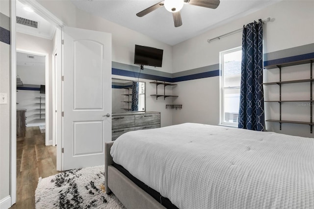 bedroom with hardwood / wood-style flooring, ceiling fan, and lofted ceiling