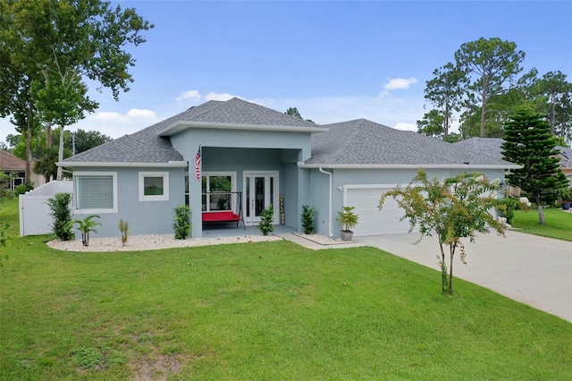 view of front of property featuring a garage, a front lawn, and french doors