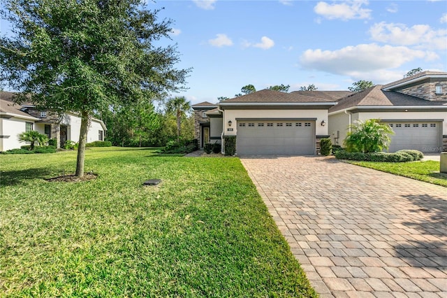 view of front of property featuring a garage and a front lawn