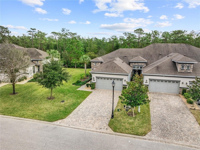 view of front of property featuring a garage and a front lawn