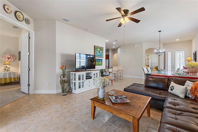 living room featuring light tile patterned flooring and ceiling fan with notable chandelier