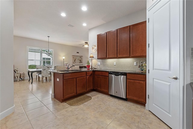 kitchen featuring pendant lighting, backsplash, light tile patterned flooring, stainless steel dishwasher, and kitchen peninsula