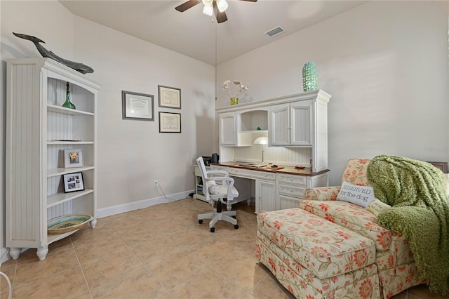 tiled home office featuring ceiling fan