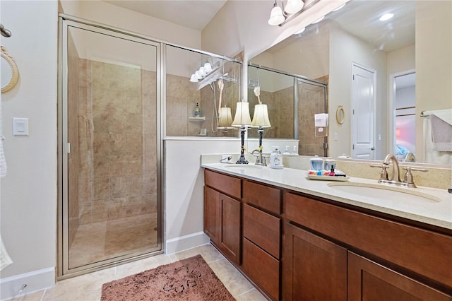 bathroom featuring vanity, tile patterned floors, and a shower with door