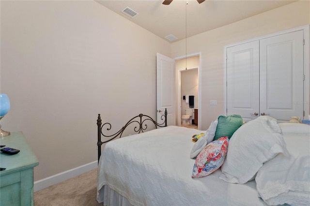 bedroom with ceiling fan, ensuite bath, a closet, and light carpet