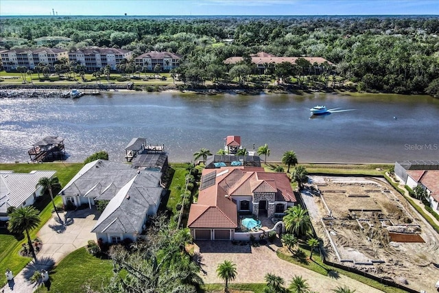 birds eye view of property with a water view