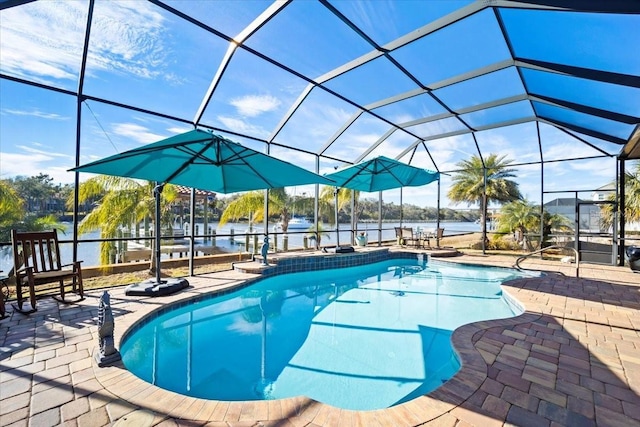 view of swimming pool with a lanai, a patio, and a water view