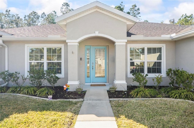 entrance to property featuring a yard