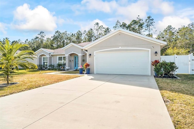 single story home featuring a garage and a front lawn