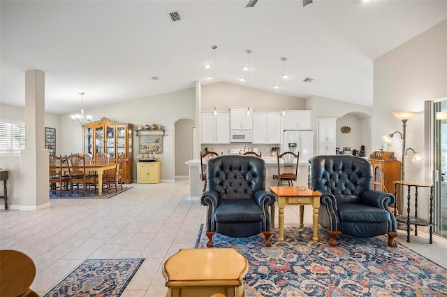 living room featuring high vaulted ceiling and a notable chandelier