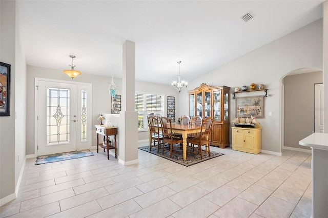 entryway with an inviting chandelier and light tile patterned floors