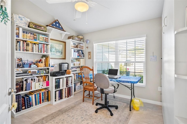 home office with light tile patterned floors and ceiling fan