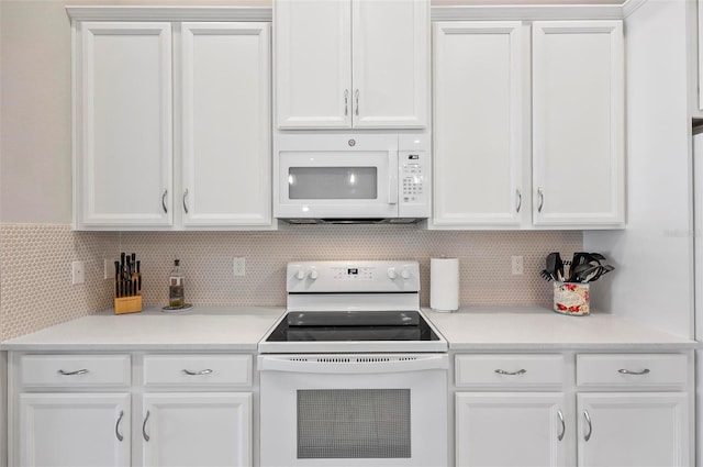 kitchen with white cabinetry, white appliances, and backsplash