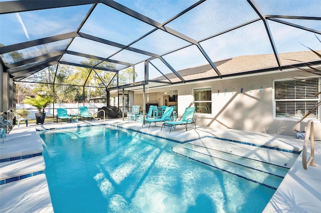 view of swimming pool featuring a lanai and a patio area