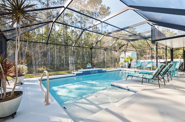 view of pool with a patio and glass enclosure