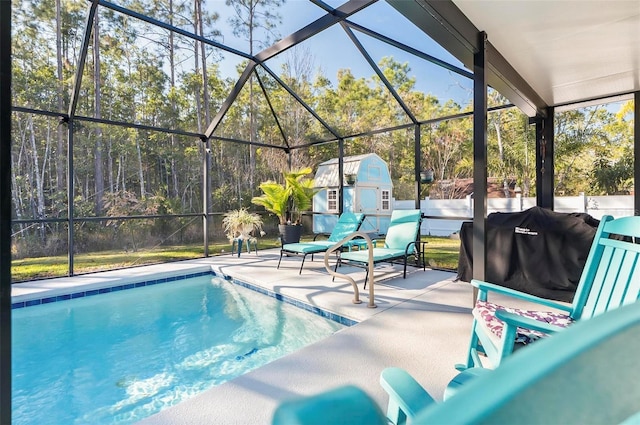 view of pool featuring a patio, an outdoor structure, area for grilling, and glass enclosure