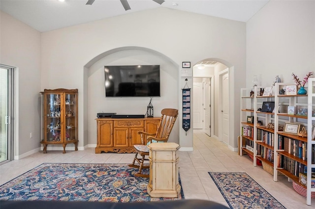 living room featuring vaulted ceiling, ceiling fan, and light tile patterned flooring