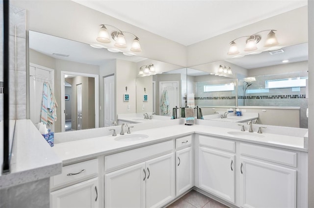 bathroom featuring walk in shower, tile patterned floors, and vanity