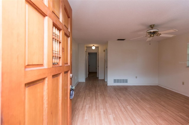 unfurnished room featuring ceiling fan and light hardwood / wood-style floors