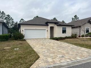 view of front of property with a garage and a front lawn