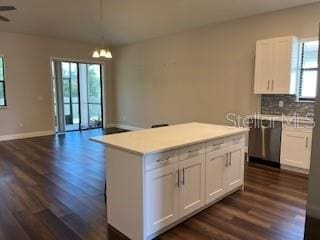 kitchen with white cabinetry, a kitchen island, and pendant lighting