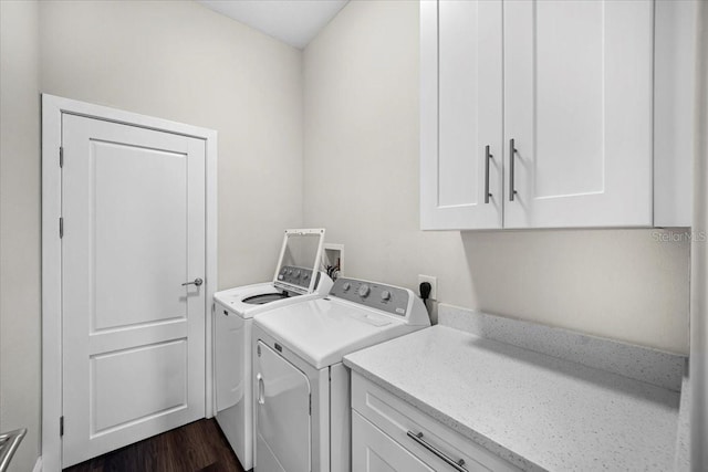 laundry room featuring dark wood-type flooring, cabinets, and separate washer and dryer