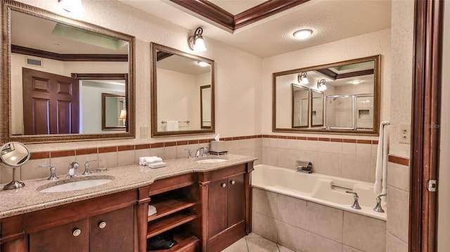 full bath with double vanity, ornamental molding, a sink, and a bath