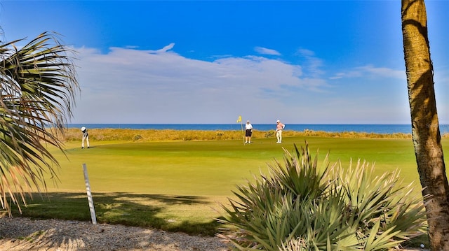 surrounding community featuring view of golf course and a water view