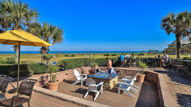 view of patio featuring a water view and a fire pit