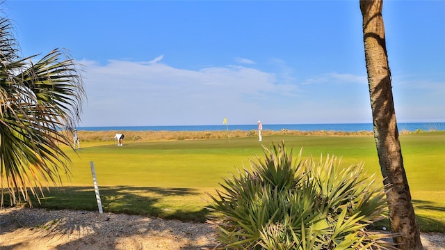 view of home's community with view of golf course and a water view