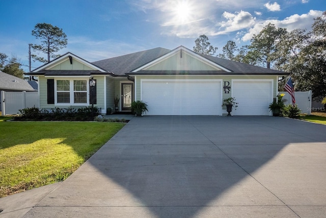 single story home with a garage and a front lawn