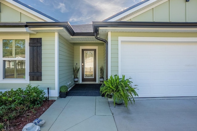 doorway to property with a garage