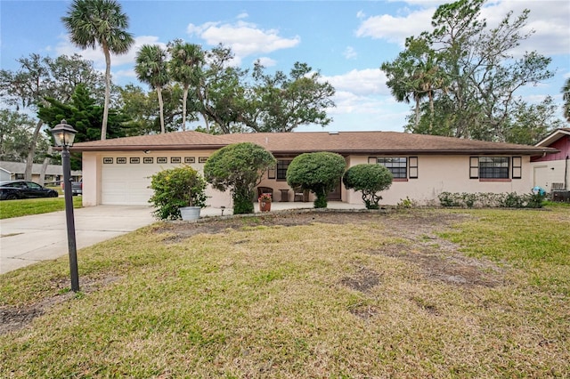 single story home featuring a garage and a front lawn