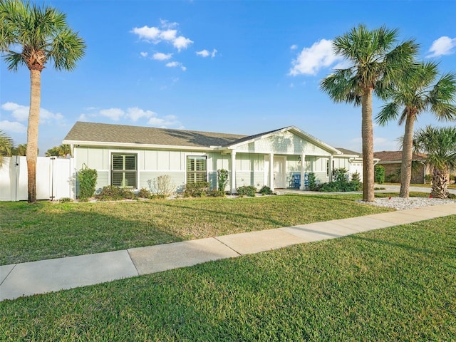 single story home featuring a front lawn