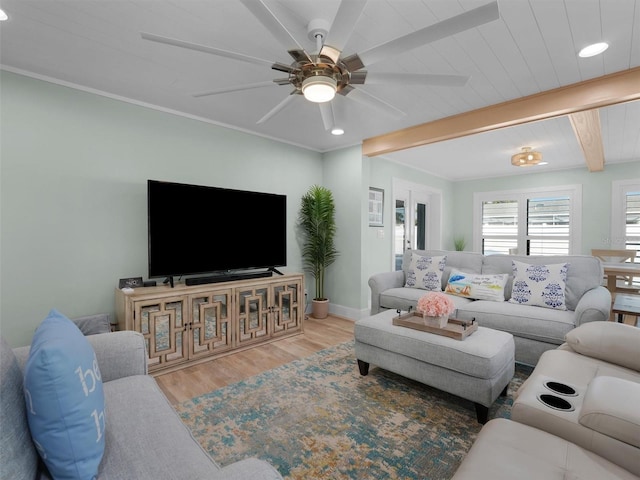 living room featuring beamed ceiling, ceiling fan, and wood-type flooring