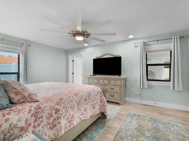 bedroom with ceiling fan and light hardwood / wood-style floors