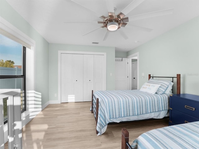 bedroom featuring light hardwood / wood-style floors, a closet, and ceiling fan