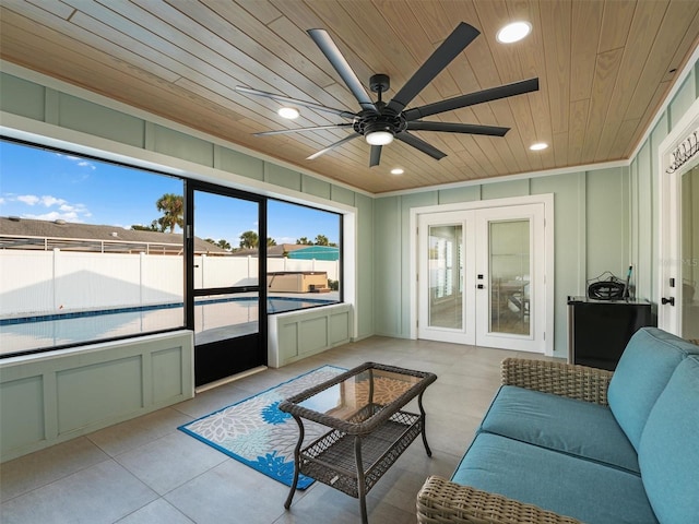 sunroom / solarium featuring wooden ceiling, ceiling fan, and french doors