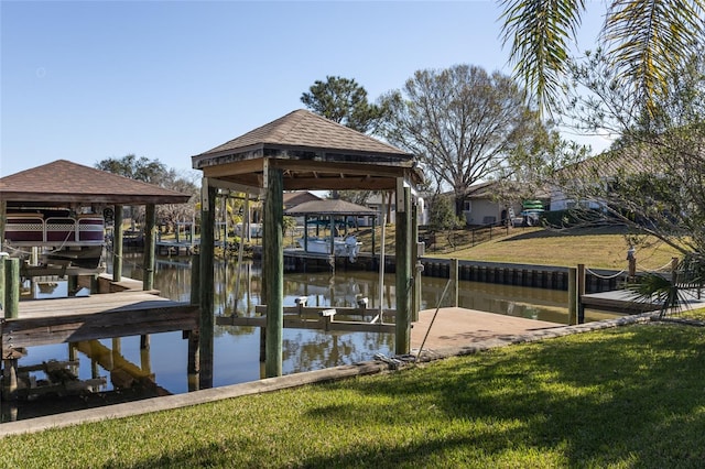 dock area with a water view and a yard