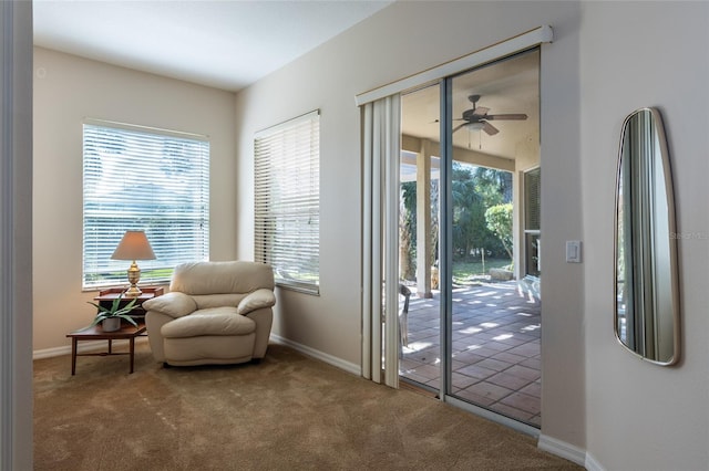 sitting room featuring ceiling fan, a healthy amount of sunlight, and carpet flooring